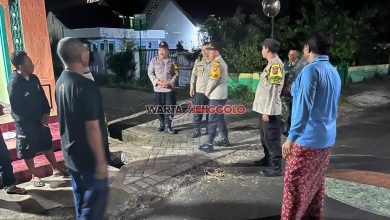 Kasi Propam Polres Kediri berbincang dengan warga saat patroli malam di Pos Satkamling Desa Dungus.